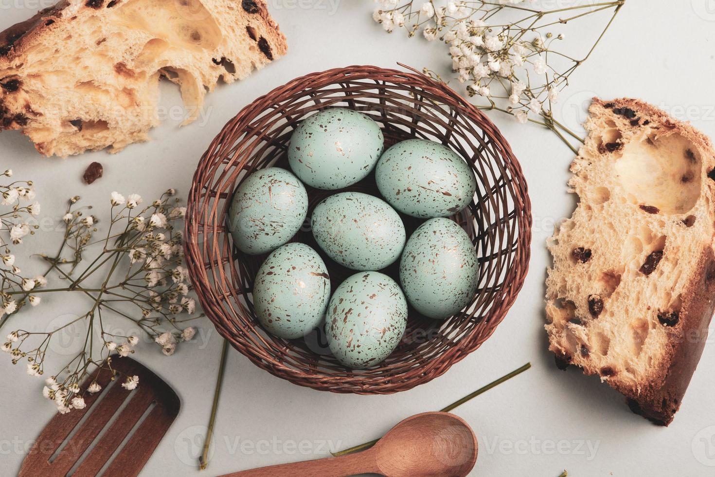 banner. Easter frame with eggs and feathers on a blue wooden background. Minimal concept. View from above. Card with copy space for text. photo