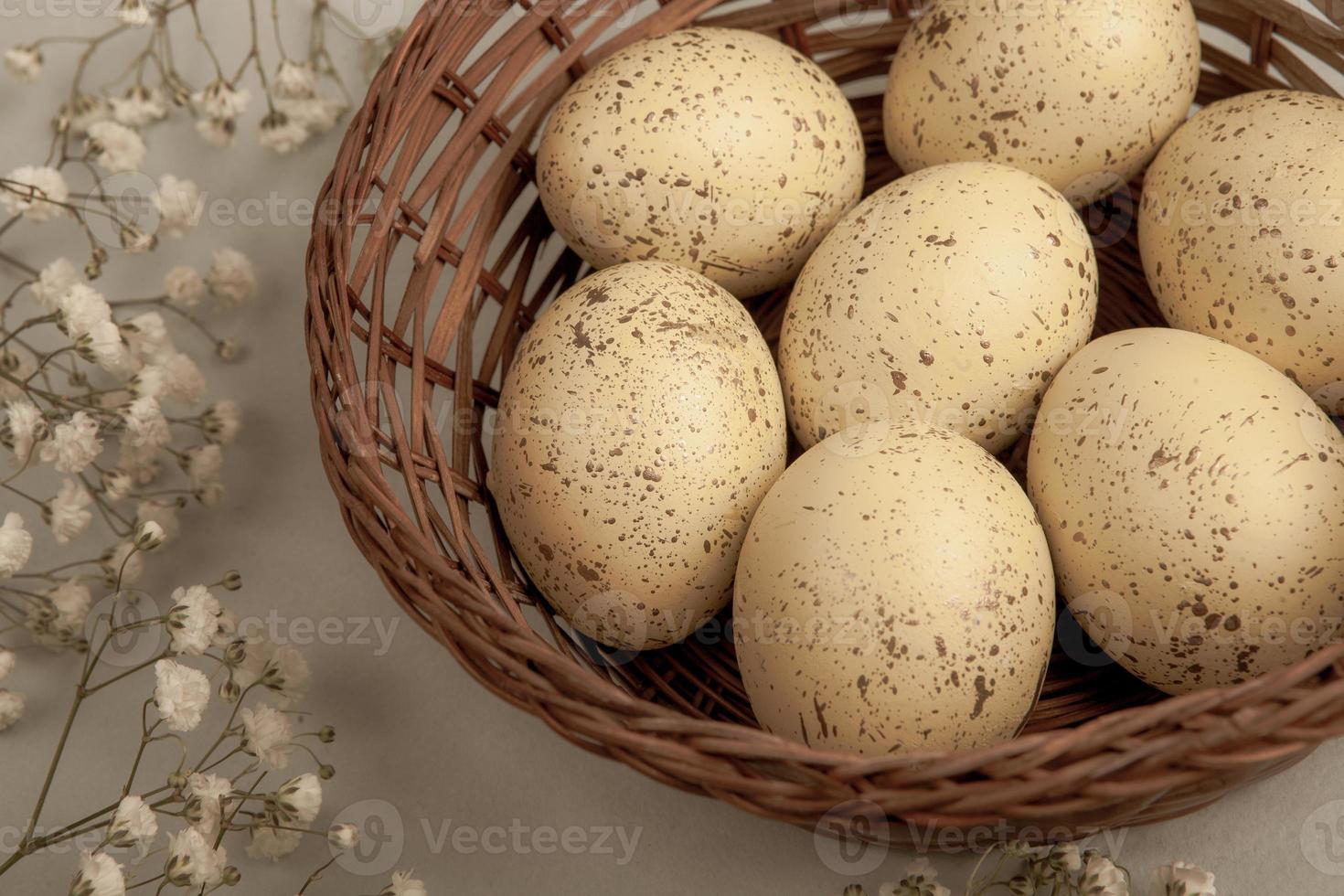 banner. Easter frame with eggs and feathers on a blue wooden background. Minimal concept. View from above. Card with copy space for text. photo