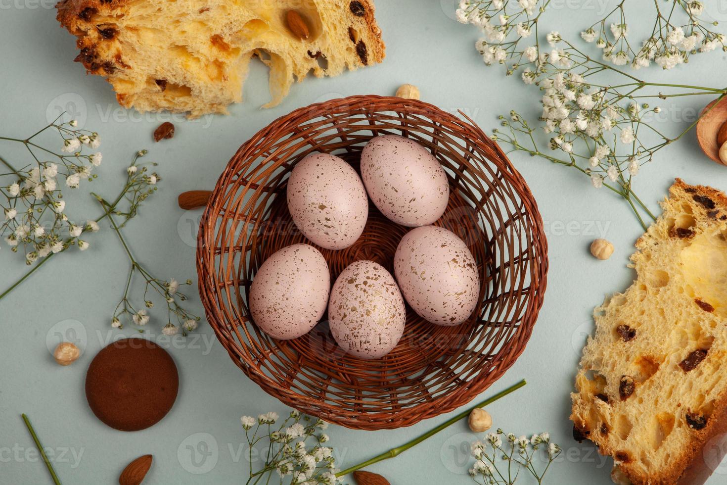 banner. Easter frame with eggs and feathers on a blue wooden background. Minimal concept. View from above. Card with copy space for text. photo