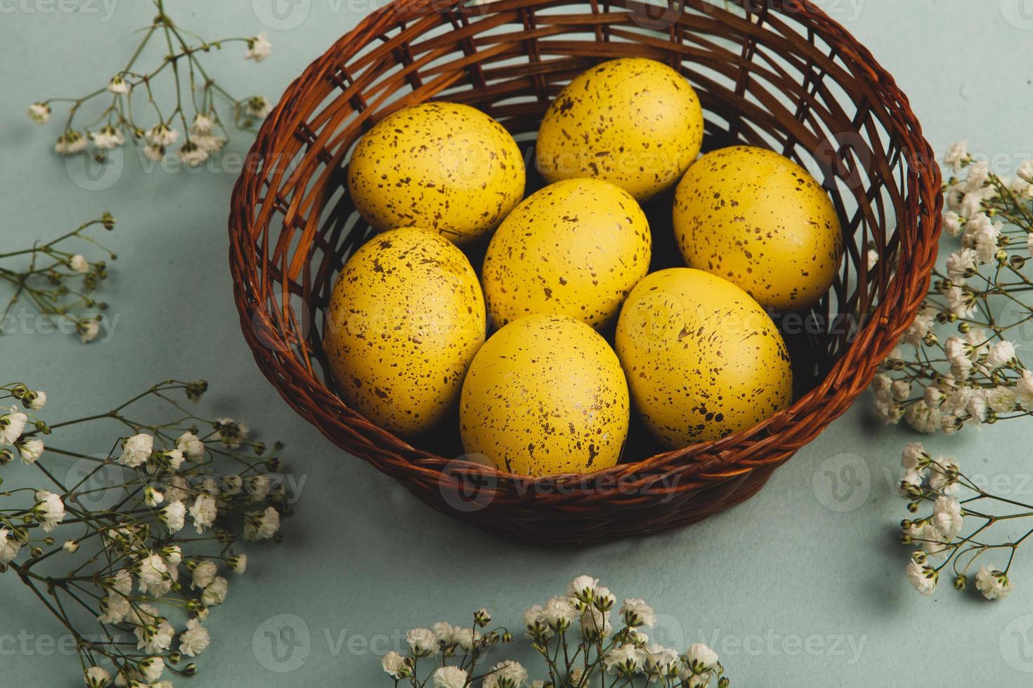 banner. Easter frame with eggs and feathers on a blue wooden background. Minimal concept. View from above. Card with copy space for text. photo