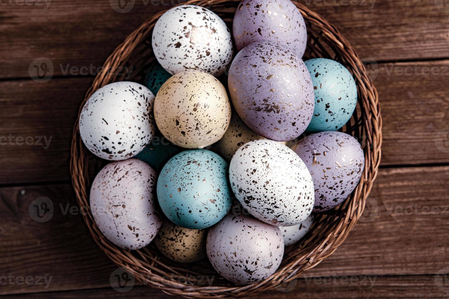 banner. Easter frame with eggs and feathers on a blue wooden background. Minimal concept. View from above. Card with copy space for text. photo