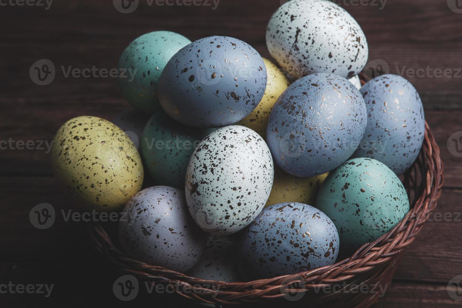 banner. Easter frame with eggs and feathers on a blue wooden background. Minimal concept. View from above. Card with copy space for text. photo