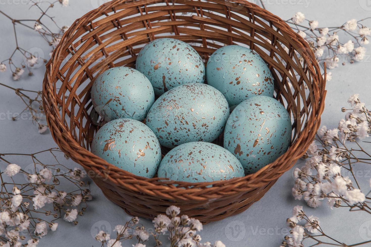 banner. Easter frame with eggs and feathers on a blue wooden background. Minimal concept. View from above. Card with copy space for text. photo