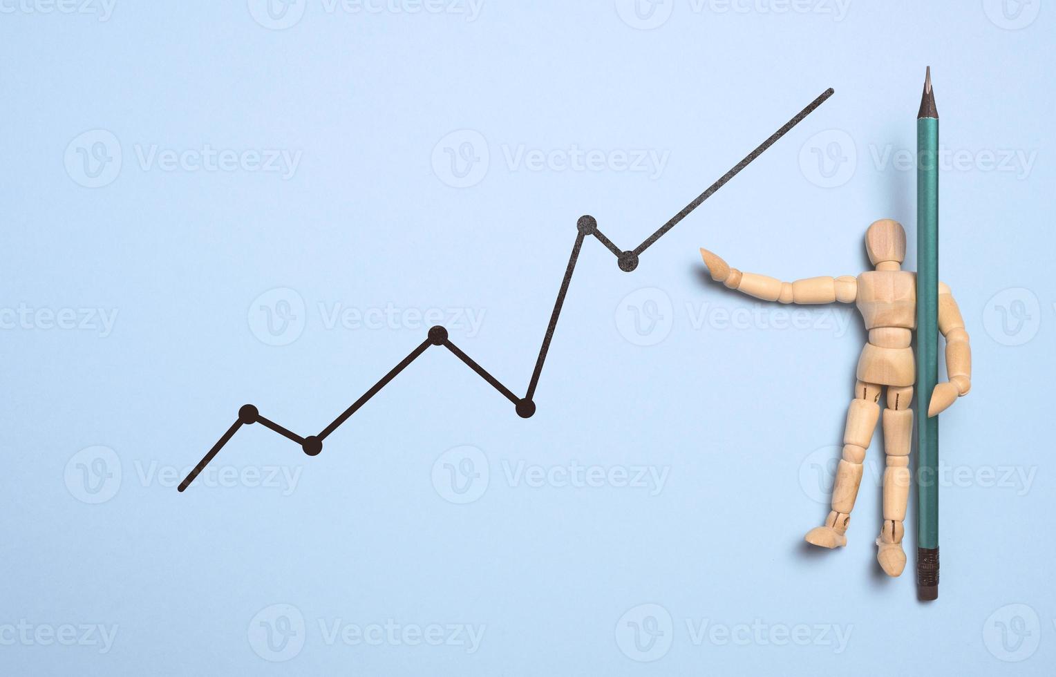 Wooden mannequin and graph with growing indicators on a blue background. Analysis of financial indicators in business, photo
