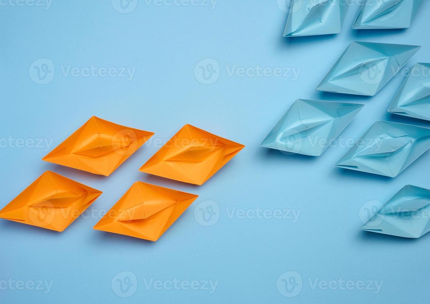 Two groups of paper boats facing each other, a concept of confrontation photo