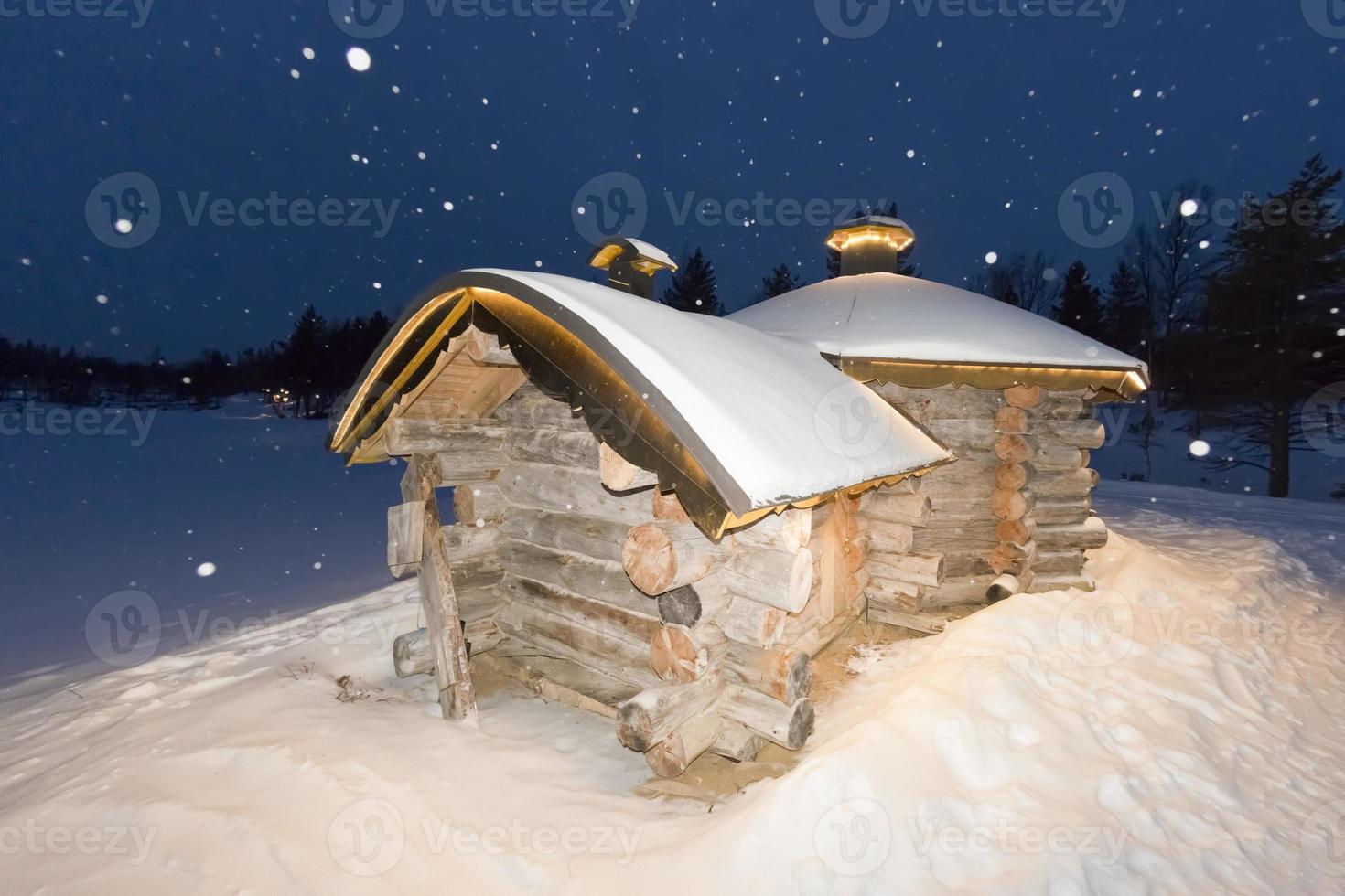 wooden hut in snow background photo