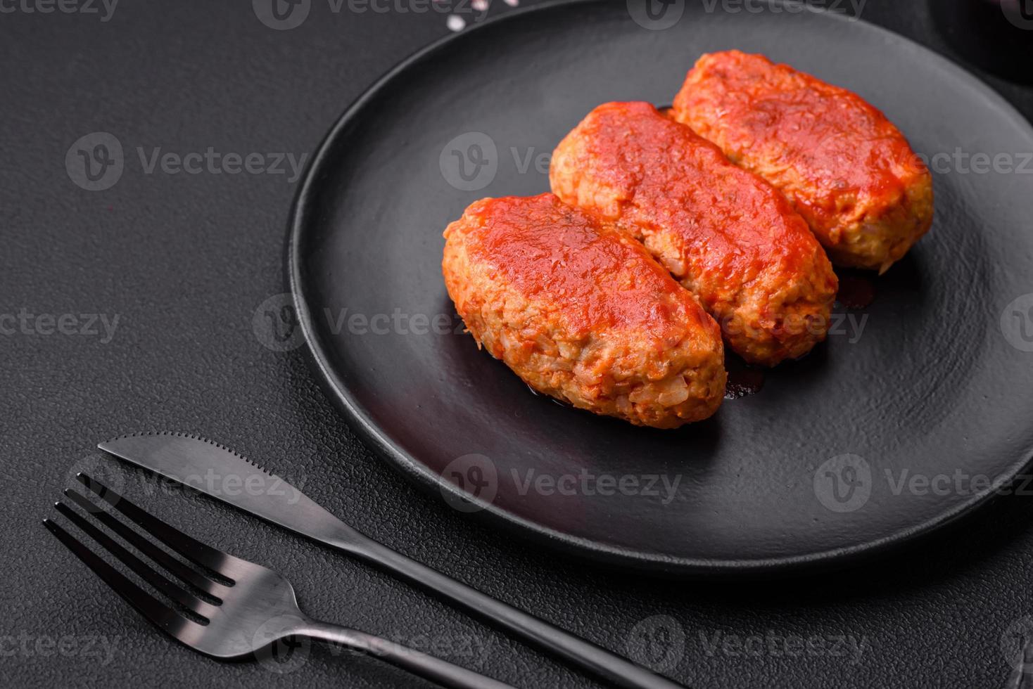 Meat cutlet or meatballs in tomato sauce with garlic, salt, spices and herbs photo