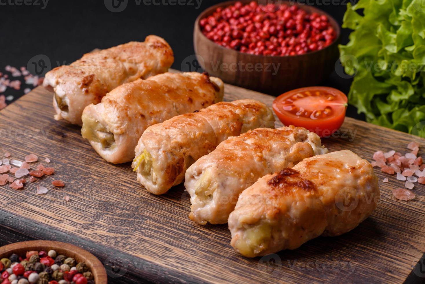Delicious baked pork or chicken roll with mushrooms, spices and herbs inside photo