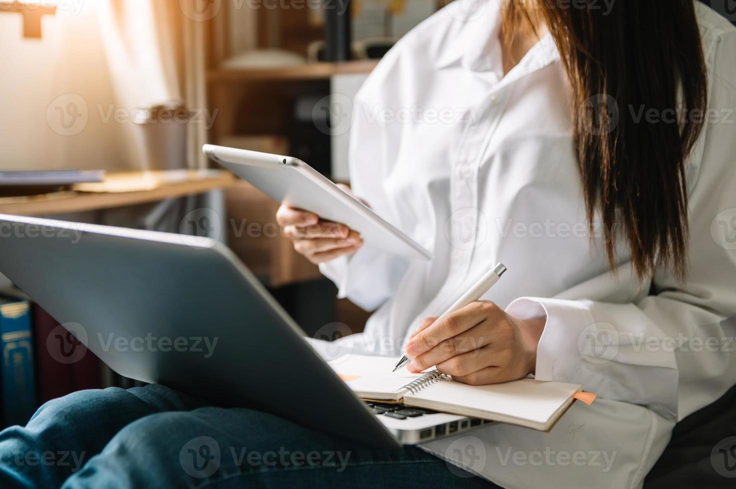 Woman using smart phone for mobile payments online shopping,omni channel,sitting on table,virtual icons graphics interface screen in morning light photo