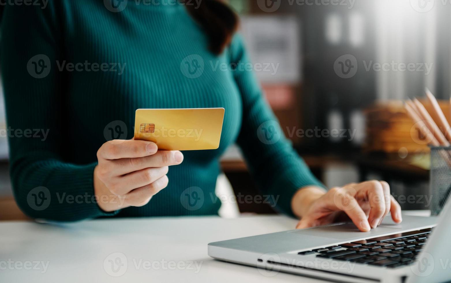 Woman using smart phone for mobile payments online shopping,omni channel,sitting on table,virtual icons graphics interface screen in morning light photo
