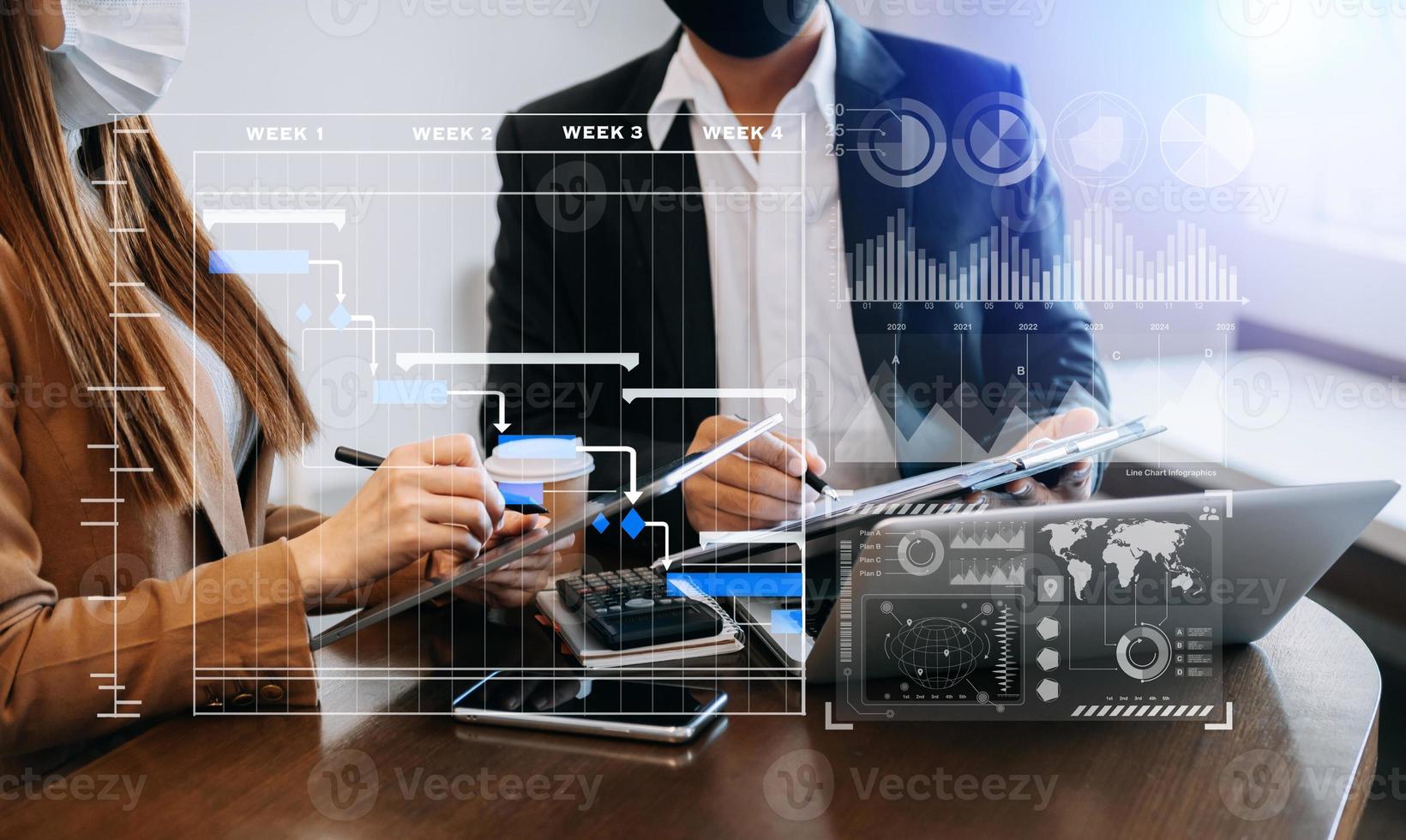 Businessman hand Project manager working and update tasks and Gantt chart scheduling virtual diagram.with smart phone, tablet and laptop in office. photo