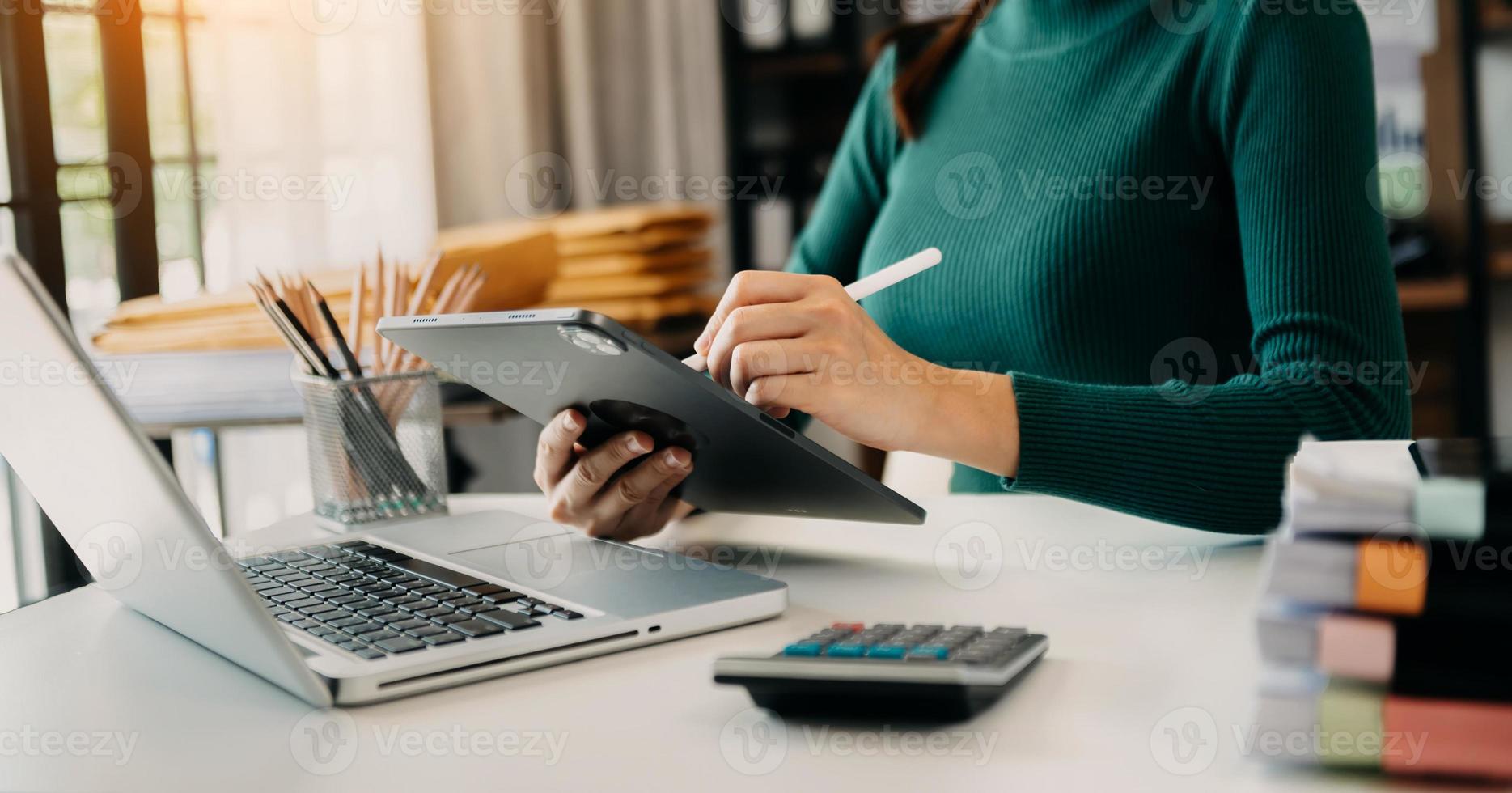 Businessman hand using smart phone laptop and tablet with social network diagram on desk as concept in morning light. photo