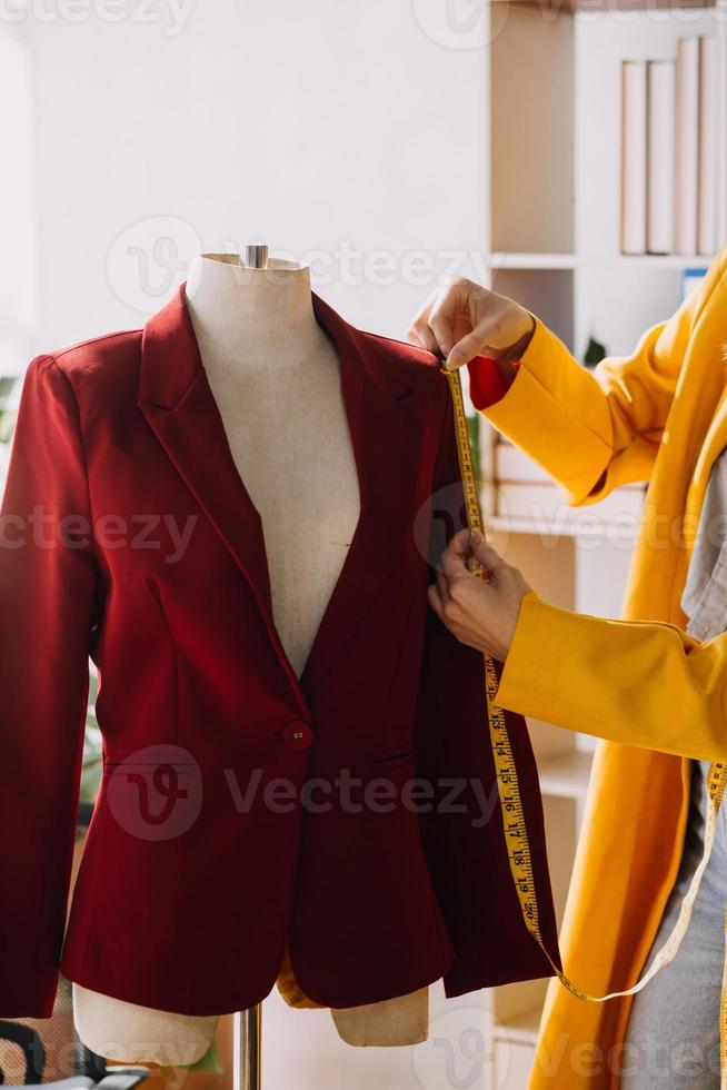 Fashion blogger concept, Young women selling clothes on video streaming.Startup small business SME, using smartphone or tablet taking receive and checking in studio photo