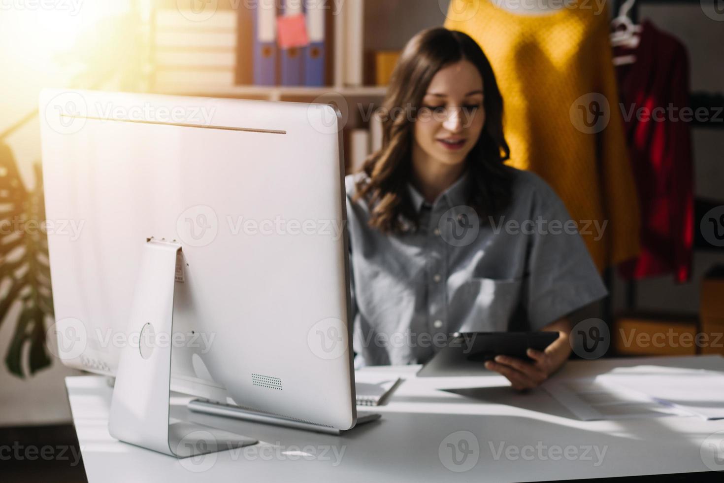 Fashion blogger concept, Young women selling clothes on video streaming.Startup small business SME, using smartphone or tablet taking receive and checking in studio photo