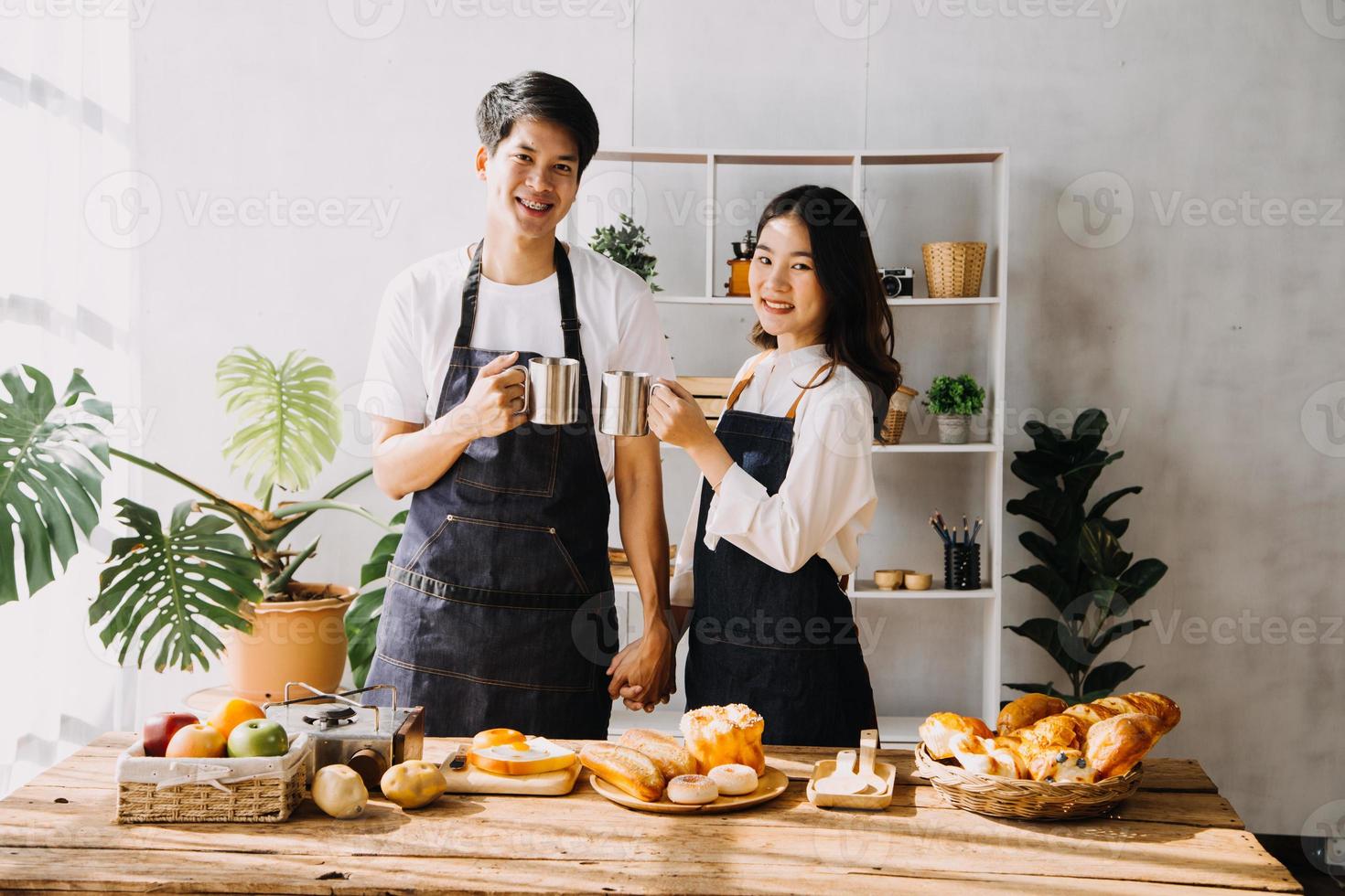 Image of newlywed couple cooking at home. Asia young couple cooking together with Bread and fruit in cozy kitchen in home photo