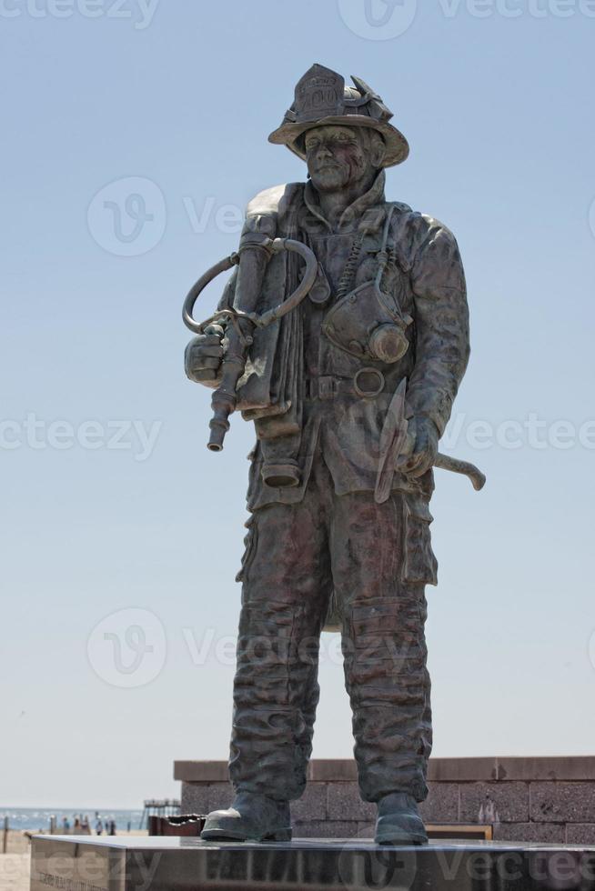 Fireman Statue on the light blue sky background photo