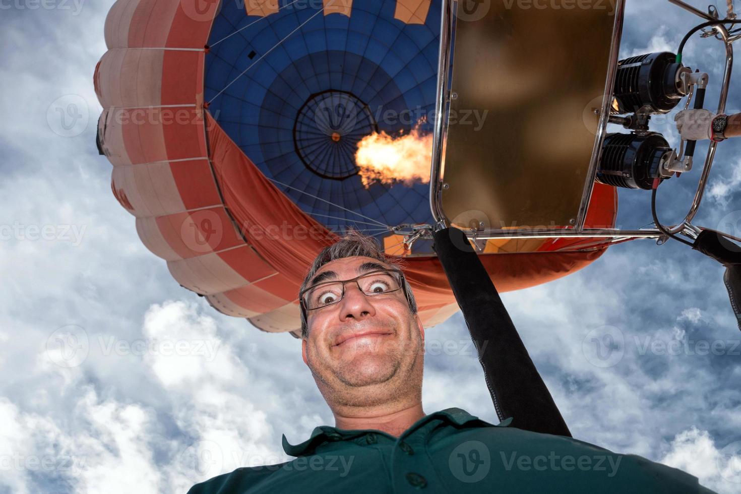 man smiling flying on balloon photo