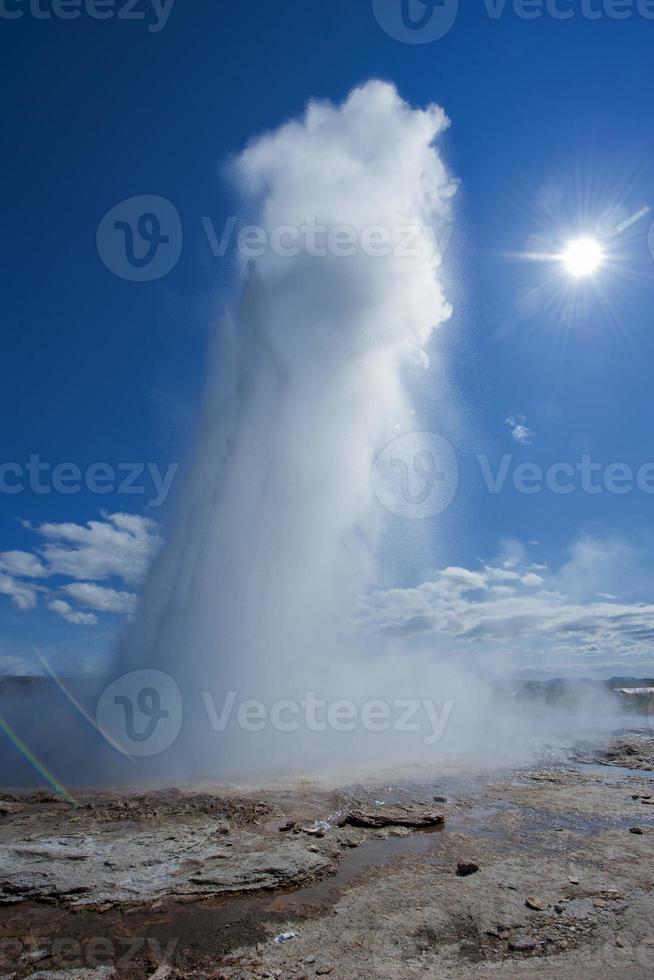 Geyser blow in Iceland while blowing water photo