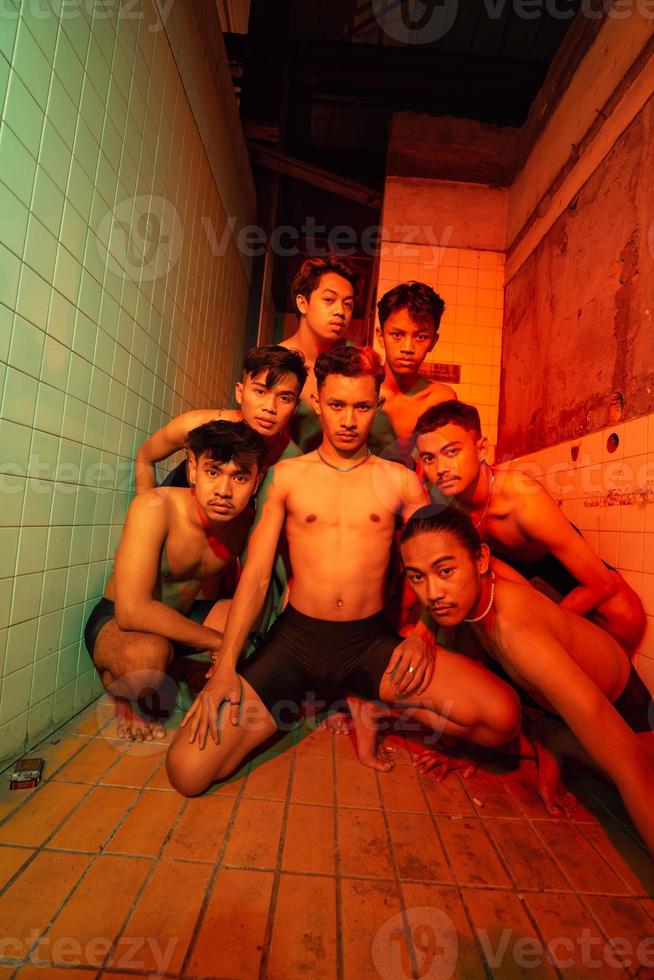 a group of naked gays are gathering and posing with their friends while celebrating world gay day photo