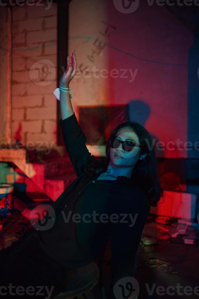 a man with long hair wearing a black shirt and clothes posing very sexy in an old factory photo