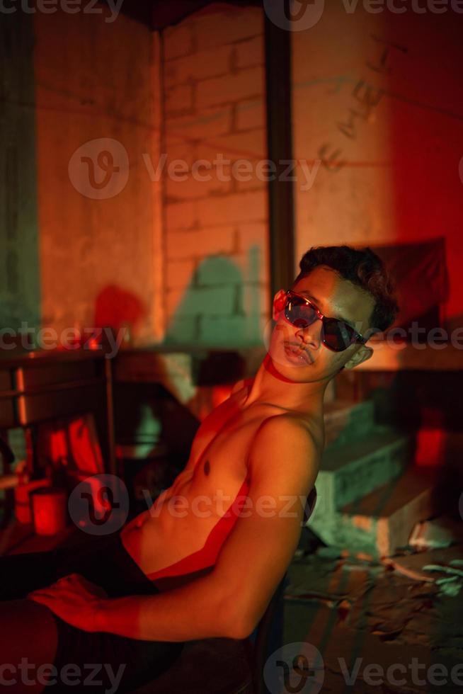 a gay man in black pants is waiting for his boyfriend in an old building photo