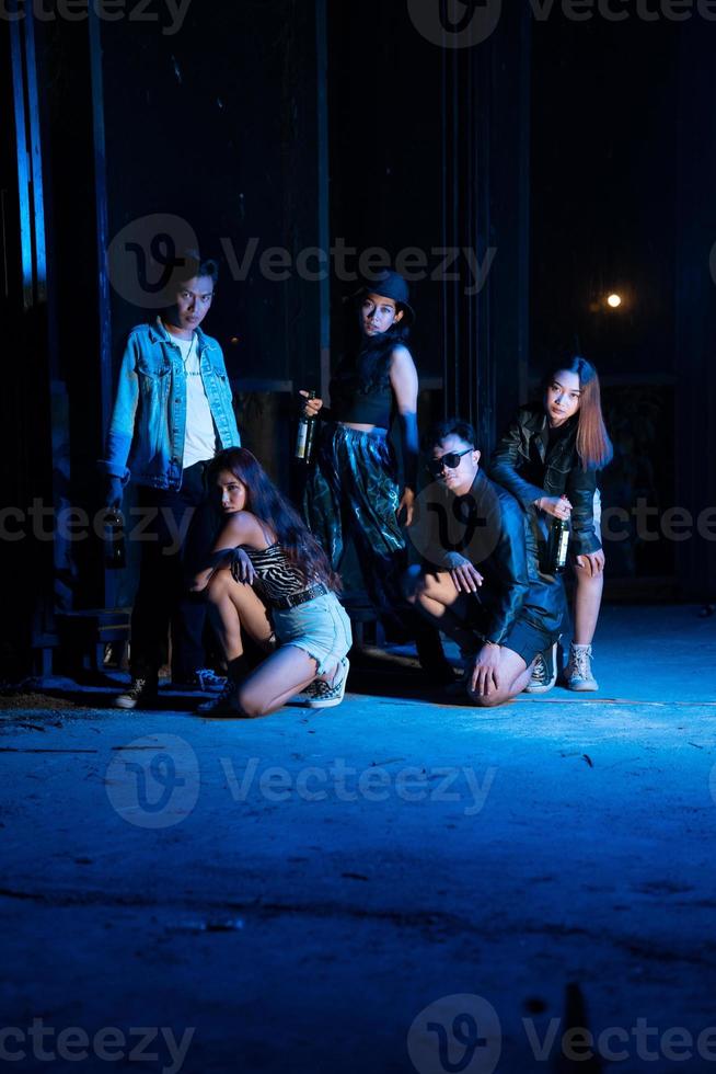 a group of sexy women and men are having fun in a cafe filled with colorful lights photo