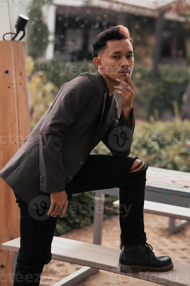 a teenage boy with blond hair posing very attractively and stylishly while wearing a blazer photo