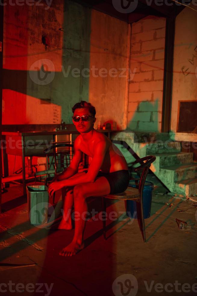 a gay man in black pants is waiting for his boyfriend in an old building photo