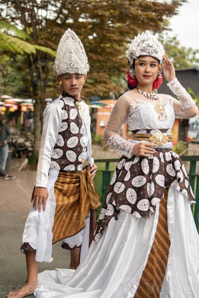 un par de novias en blanco ropa en pie juntos muy íntimamente en un turista parque foto