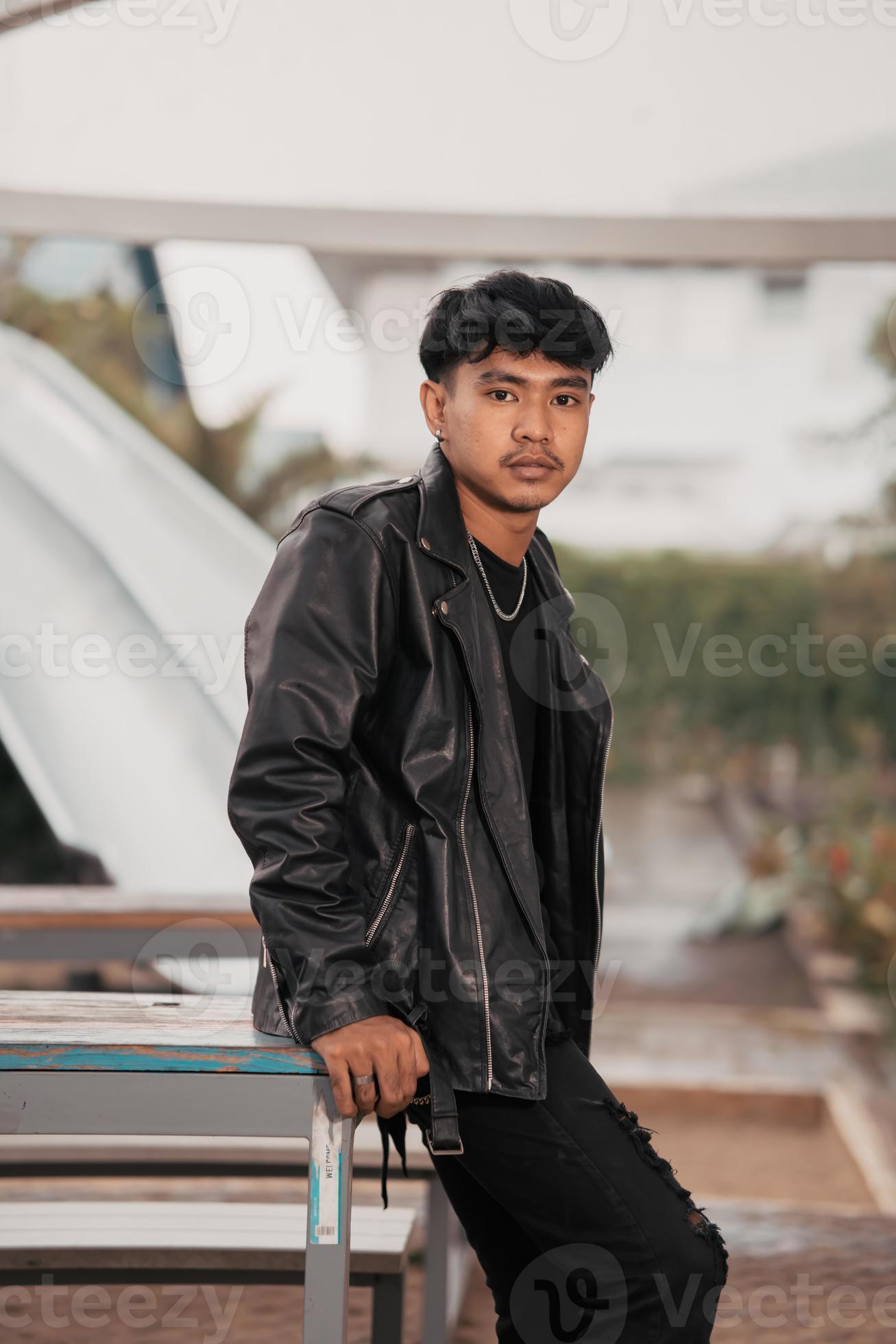 A Grown Man In A Black Leather Suit And Chain Necklace Posing Very  Dashingly In The Broad Stock Photo - Download Image Now - iStock