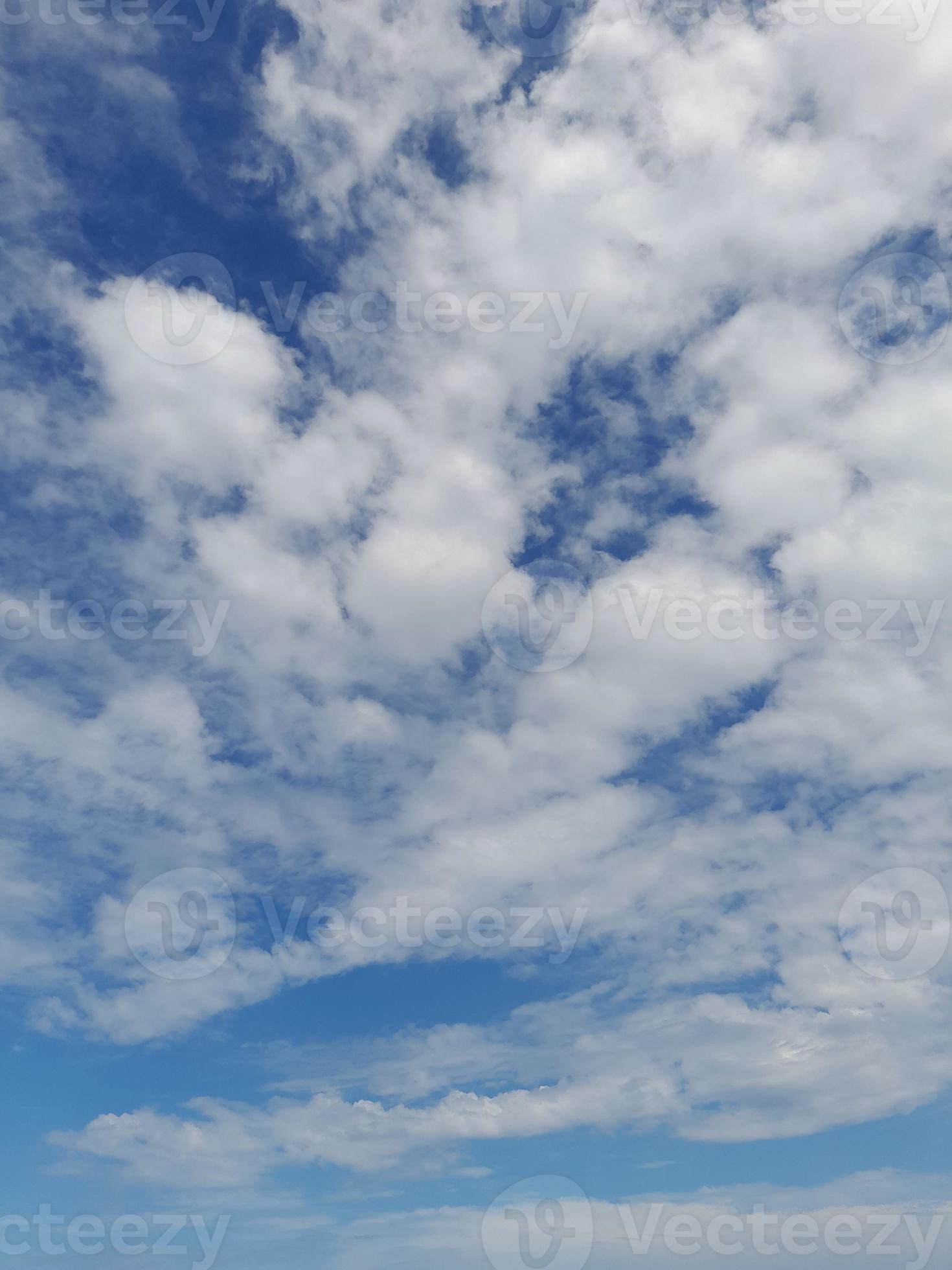 Beautiful white clouds on deep blue sky background. Large bright soft