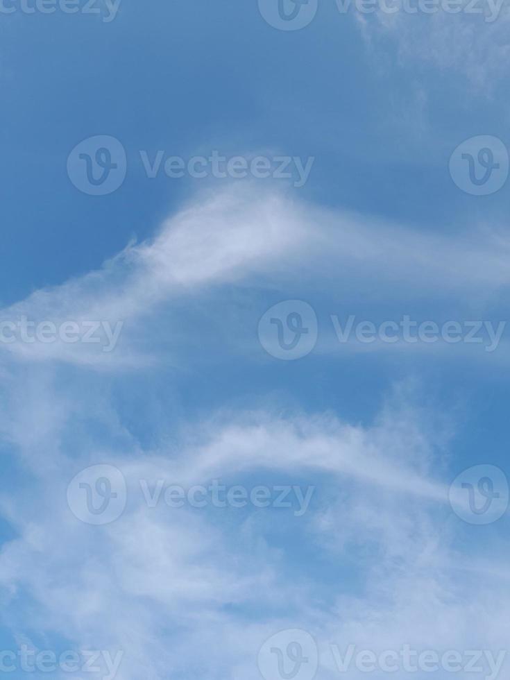 Beautiful white clouds on deep blue sky background. Large bright soft fluffy clouds are cover the entire blue sky. photo