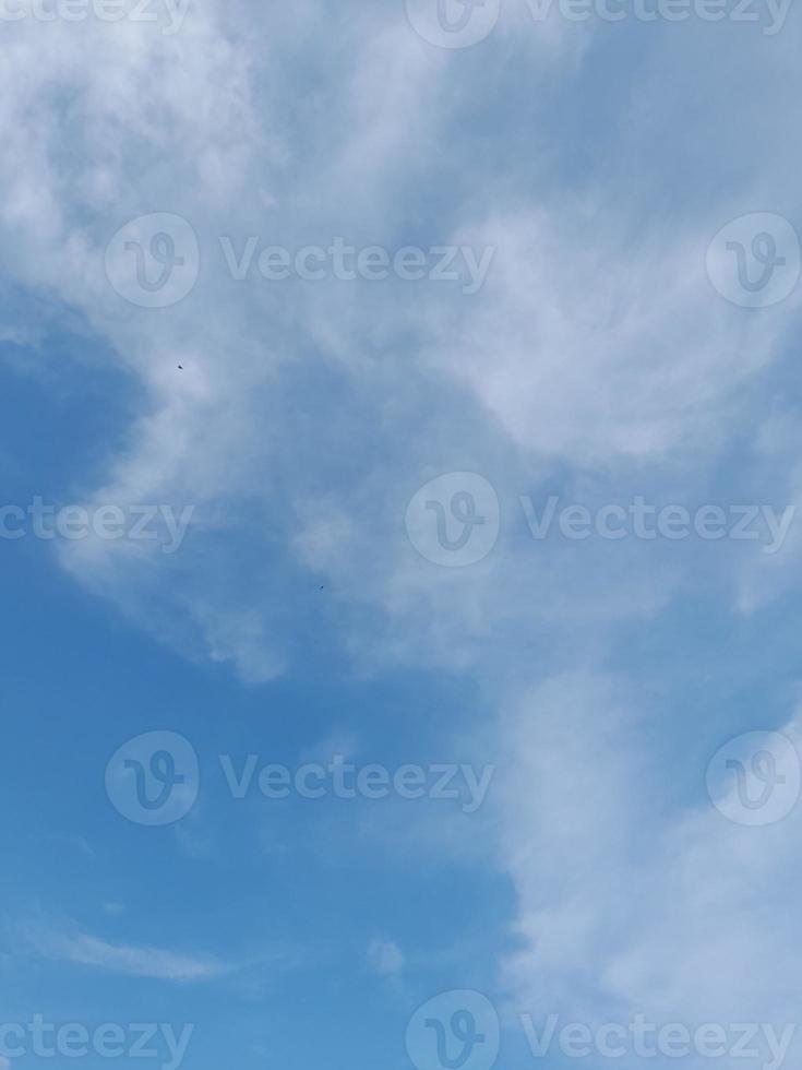 Beautiful white clouds on deep blue sky background. Large bright soft fluffy clouds are cover the entire blue sky. photo