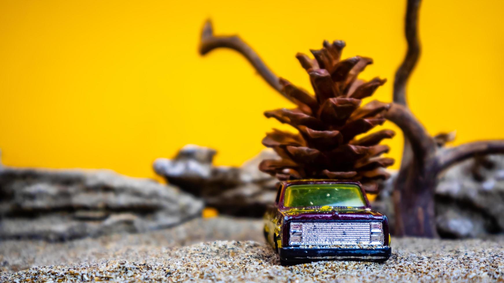 toy car hauling pinecones on an orange background photo