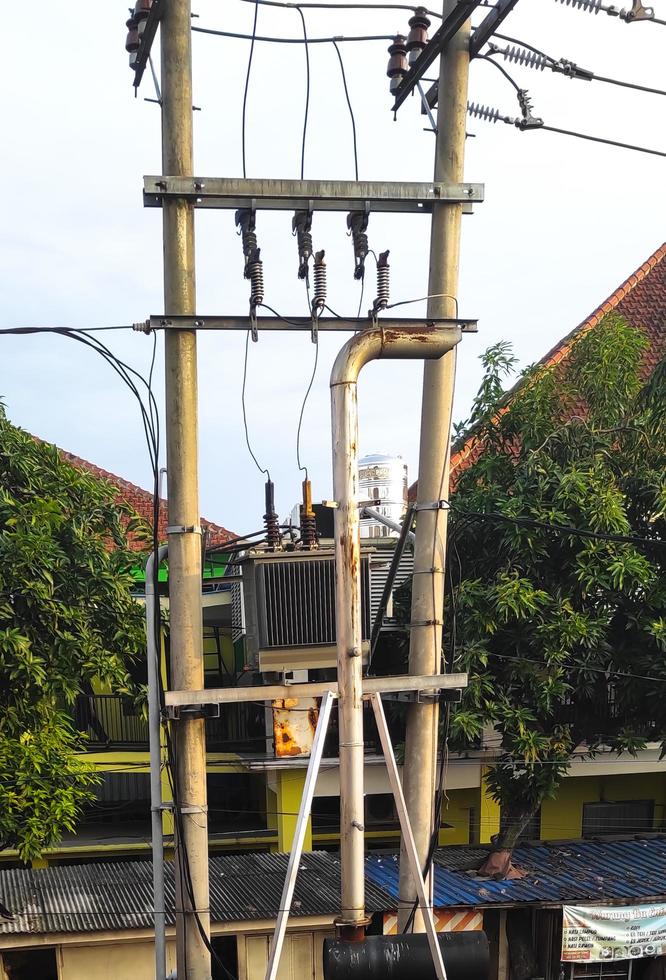 Sidoarjo, Jawa timur, Indonesia, 2023 -  the PLN electricity pole substation is in a densely populated residential area photo