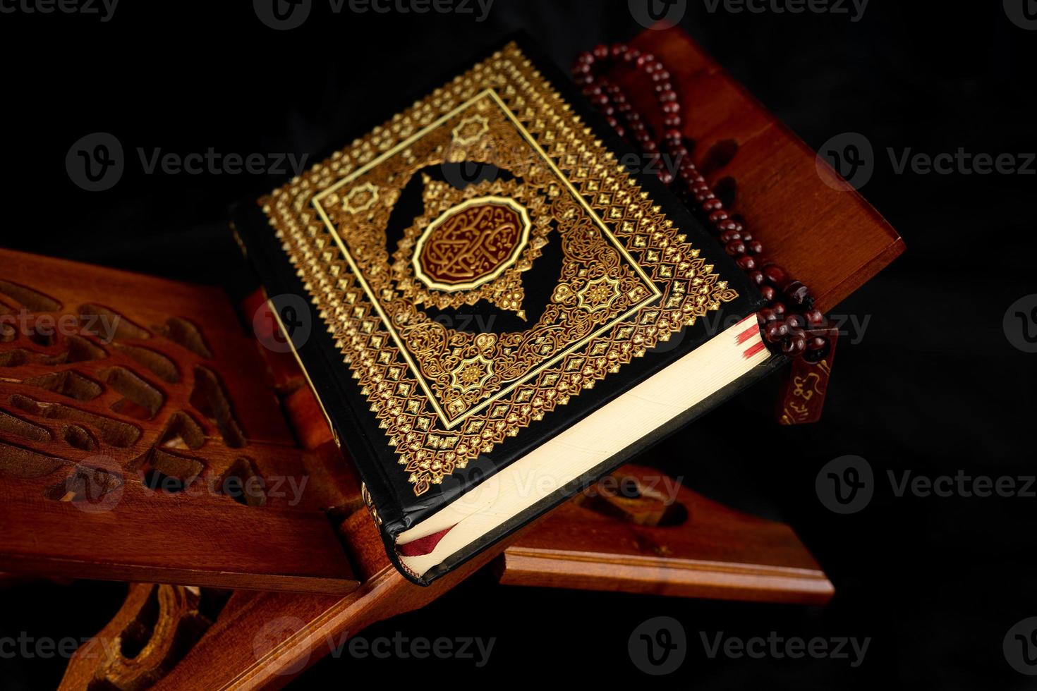 Quran book with a rosary on the table photo