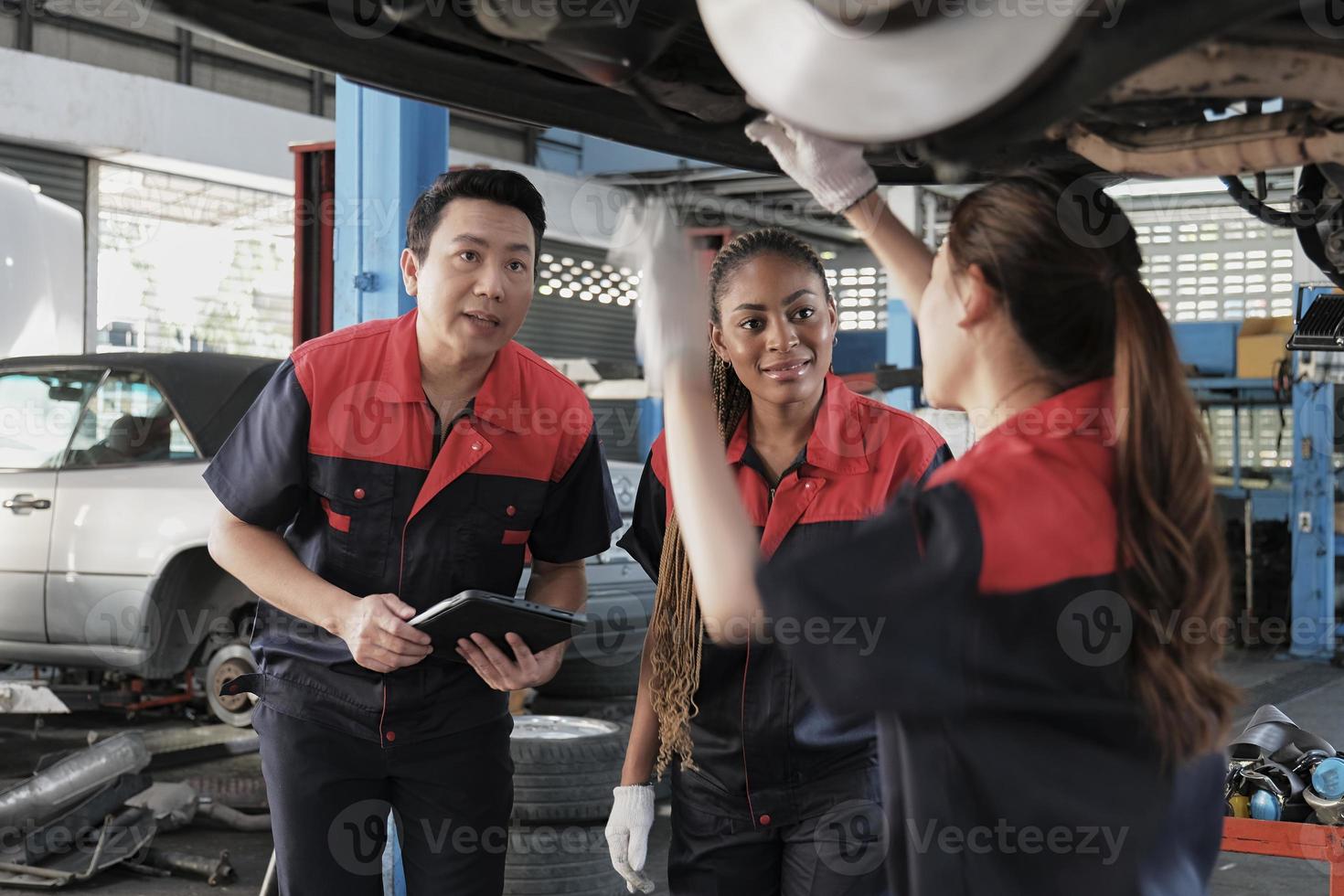A male professional automotive supervisor and Black female inspector