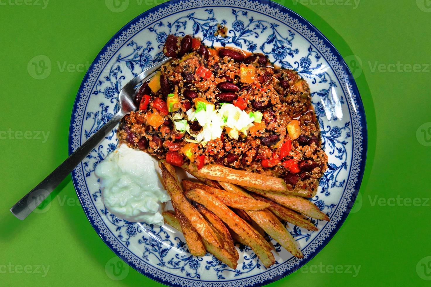 Fry fries with french bean or string beans with grounded beef. Served in plate. photo