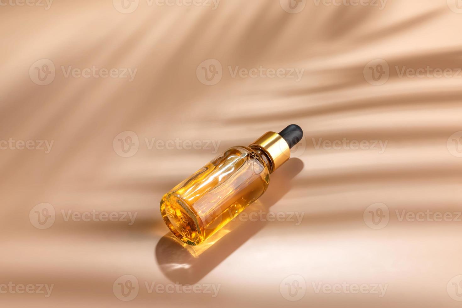 Dropper glass Bottle Mock-Up. dropper pipette with serum or essential oil on beige backgound with caustic shadows for product presentation. Skincare cosmetic. Beauty concept for face body care. photo