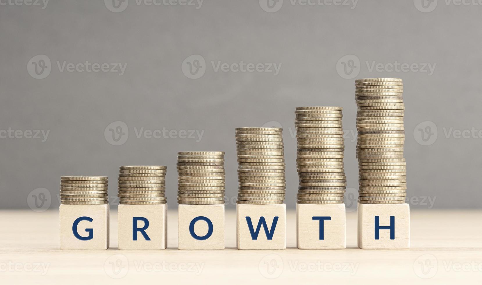 Money or revenue Growth concept. Text on Wooden blocks and Stacking coins. Copy space photo