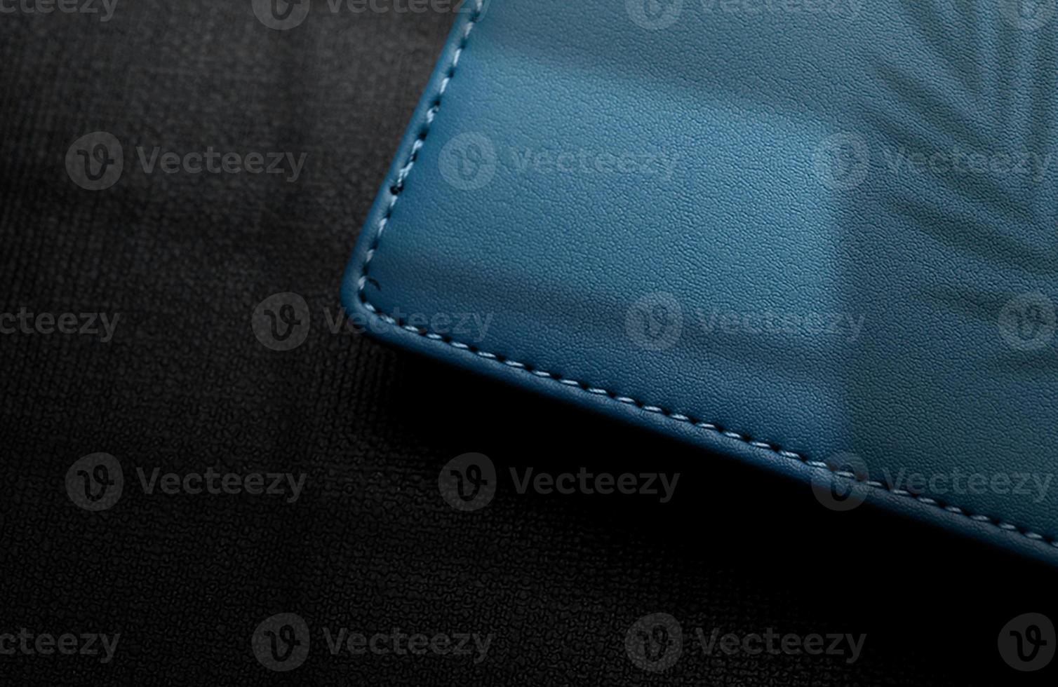 Logo mockup on leather box in blue color on black background with shadows photo