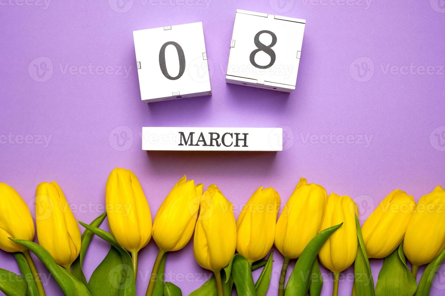 Beautiful yellow tulips and calendar on pastel purple background. Concept Women's Day, March 8. Flat lay photo