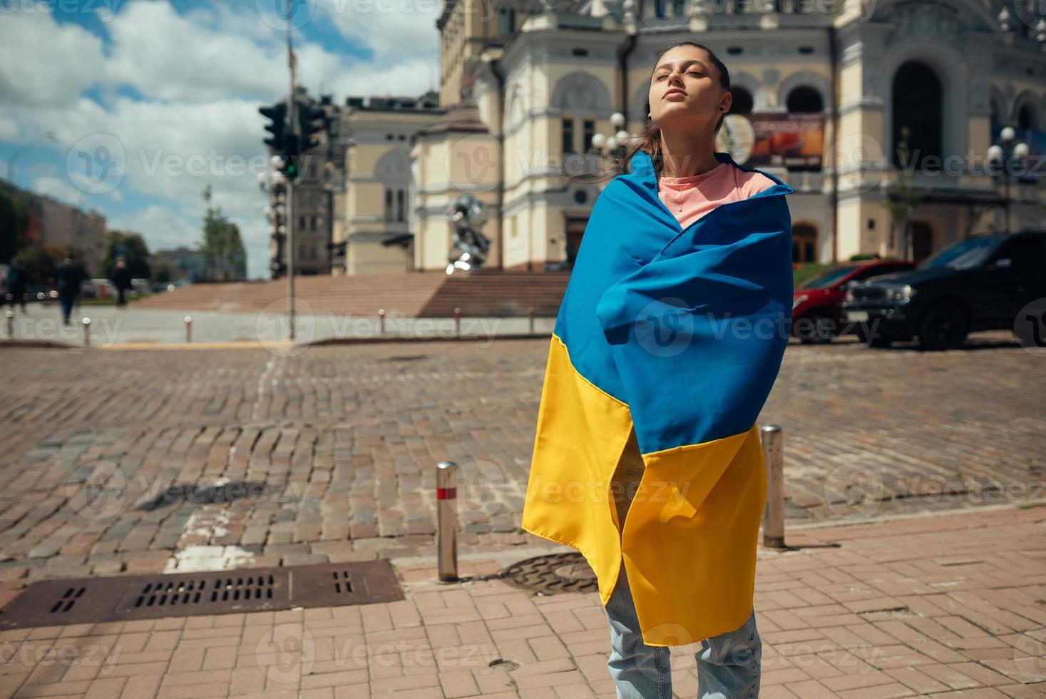 Young woman with national flag of Ukraine on the street photo