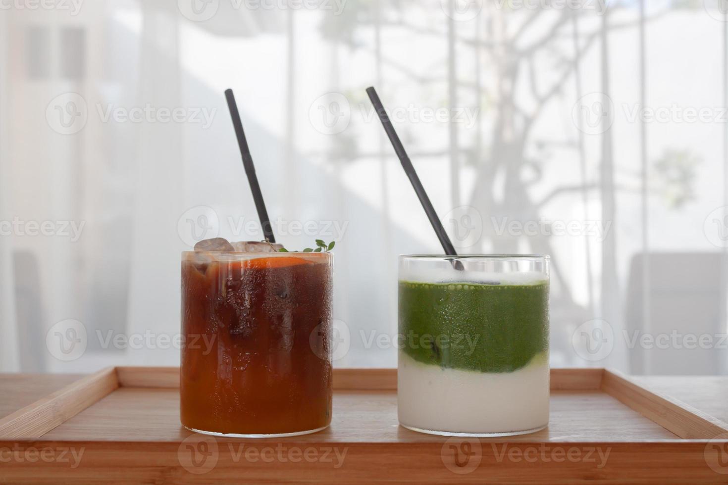 Iced americano with orange and iced matcha green tea in coffee shop photo