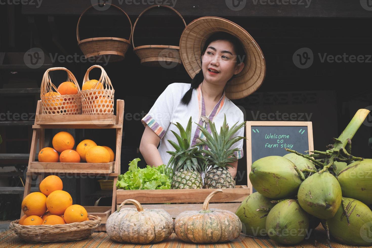 Indigenous Asian women with a natural assortment of fruits welcome tourists at the farm stay. Homestay in Thailand photo