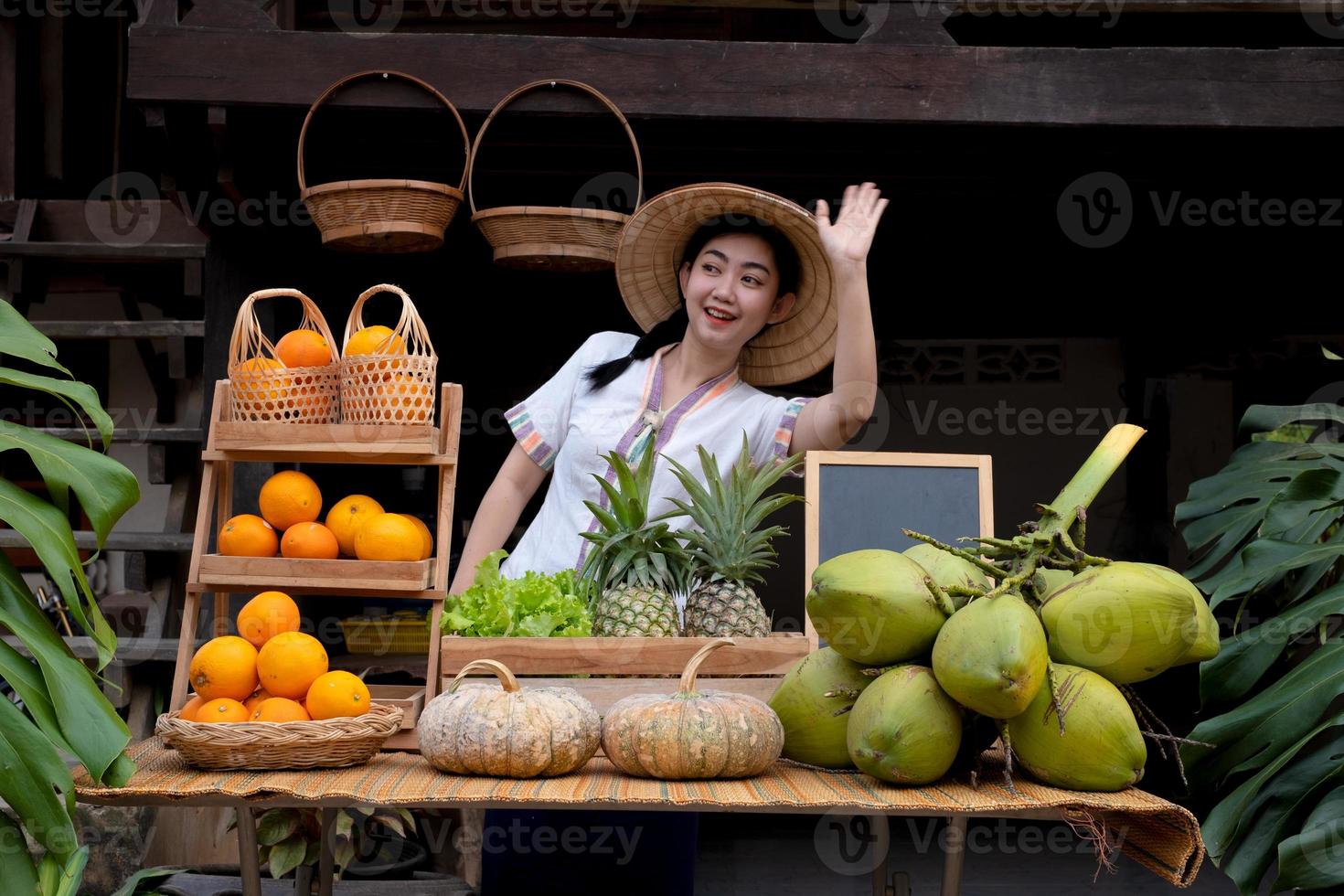 Indigenous Asian women waving to greet tourists with a natural assortment of fruits welcome tourists at the farm stay. Homestay in Thailand photo