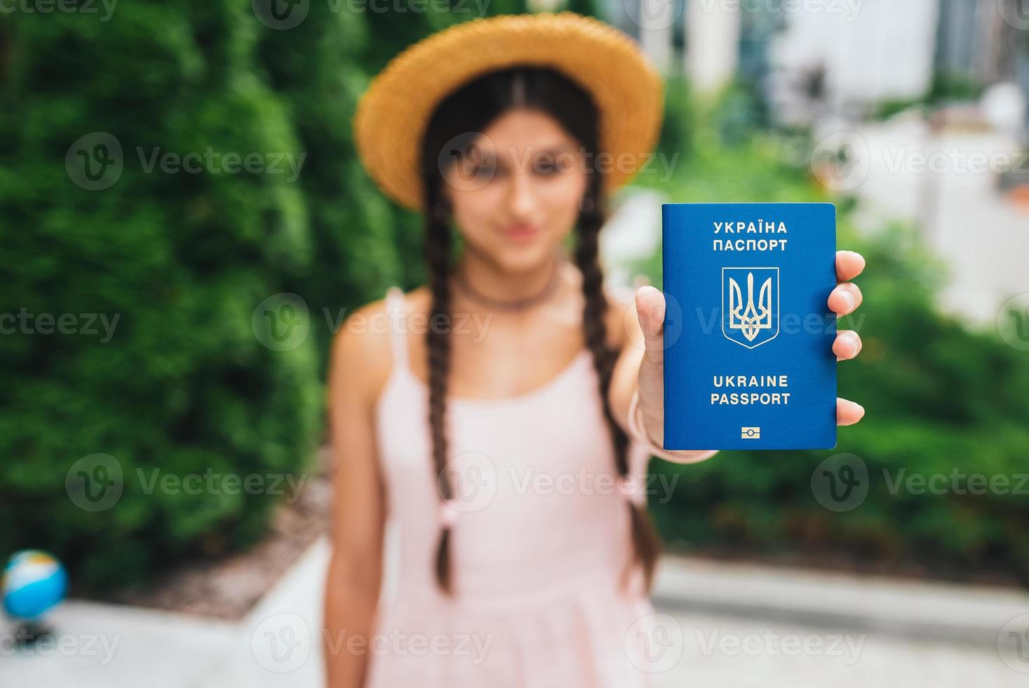 The woman shows her passport to the camera photo