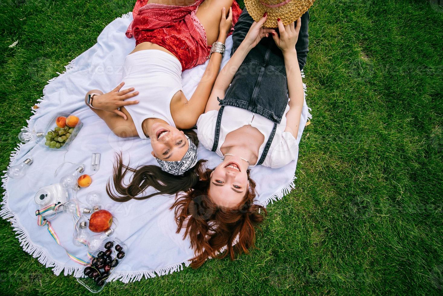 Top view, two young women lying in the park photo