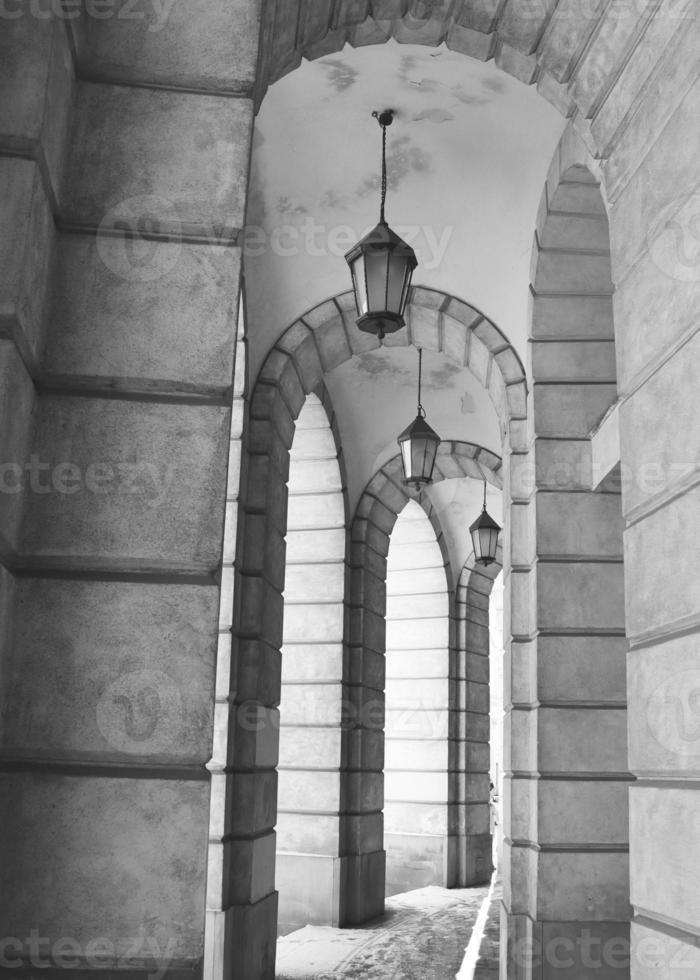 The arched stone colonnade with lanterns concept photo. Urban architectural photography. photo