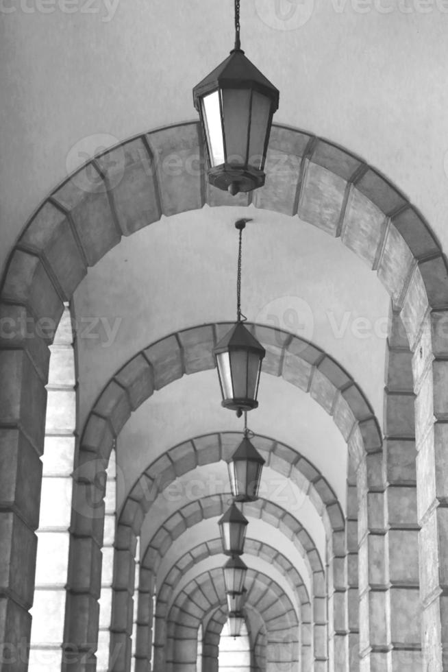 The arched stone colonnade with lanterns concept photo. Urban architectural photography. photo